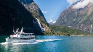 Cruise boat sailing through the dramatic fjords and waterways of Milford Sound