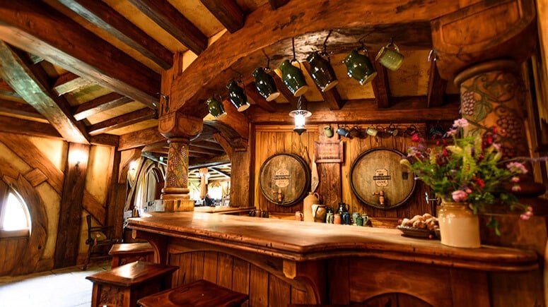 Cozy rustic wooden bar with Hobbiton-themed decorations at Hobbiton Movie Set