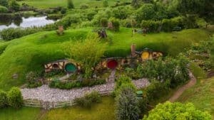 Scenic view of Hobbiton village with charming hobbit holes nestled in lush green hills