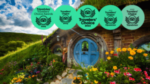Hobbiton Movie Set tour scene with green hills and a Traveler’s Choice Award badge