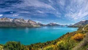 Panoramic view of Lake Wakatipu with crystal-clear water and mountain backdrop