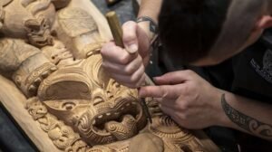 Close-up of intricate traditional Māori wood carving at Te Puia in Rotorua