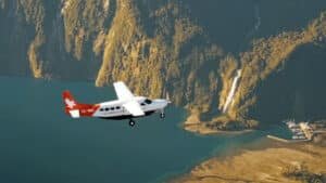 Plane flying over Milford Sound and rugged Fiordland mountains