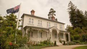 Historic building and flagstaff flying the New Zealand flag in Mansfield Garden, Hamilton Gardens