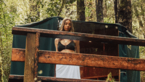 Outdoor sauna nestled among lush forest trees at Maruia River Retreat