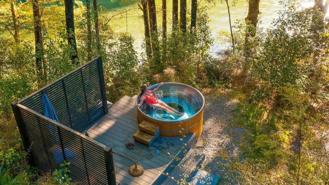 Stainless steel outdoor hot tub spa overlooking the Maruia River surrounded by forest