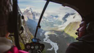 View out of helicopter window over Milford Sound peaks and valleys