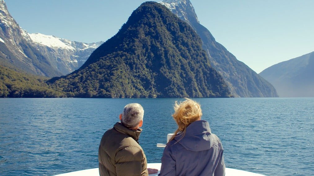 Boat cruising in Milford Sound with Mitre Peak in the background