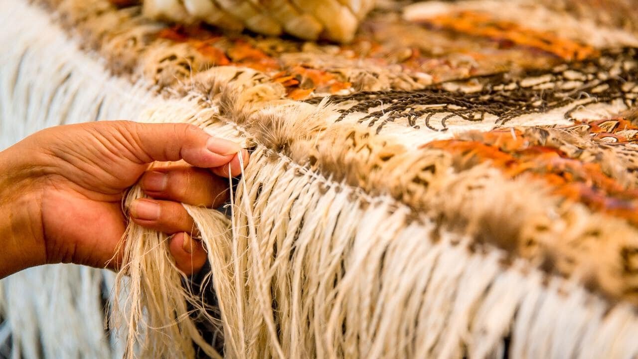 Expert demonstrating traditional Māori weaving techniques in Rotorua