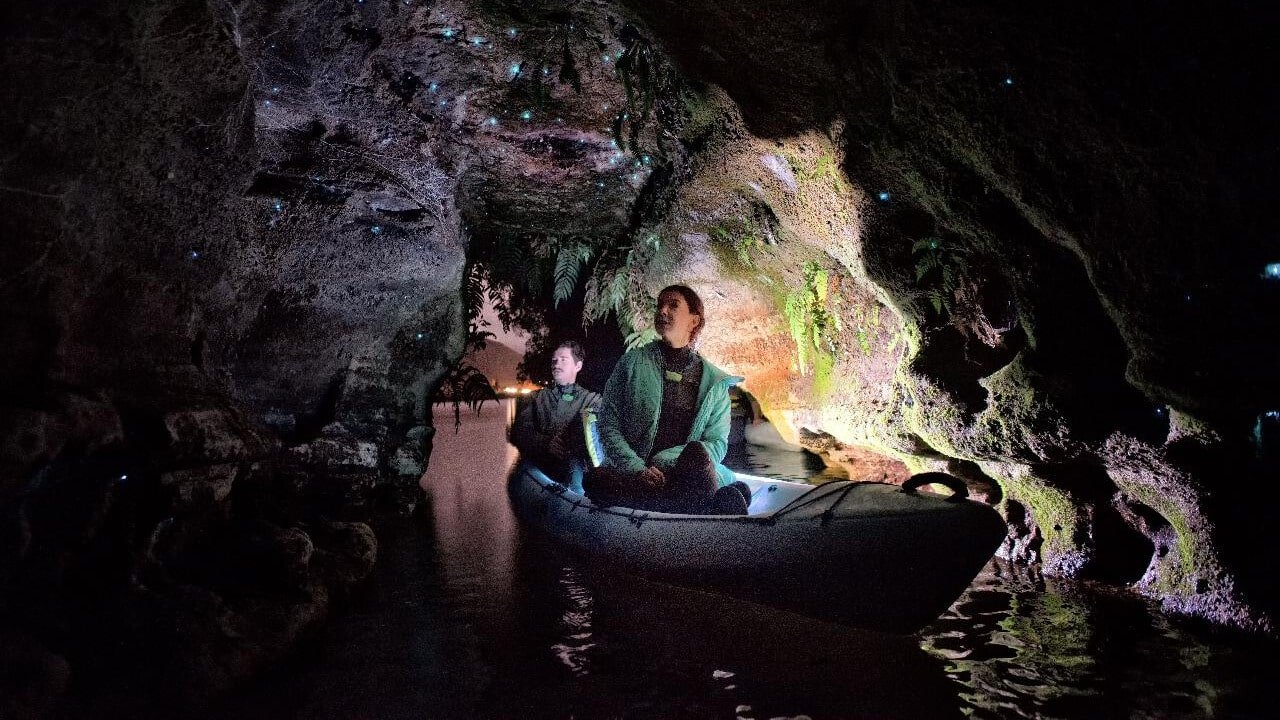 Kayaking through dark caves illuminated by glowing glow worms in Rotorua