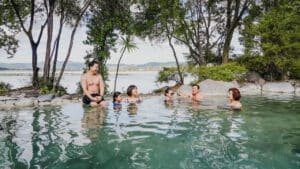Group of friends enjoying the mineral hot pools at Polynesian Spa in Rotorua