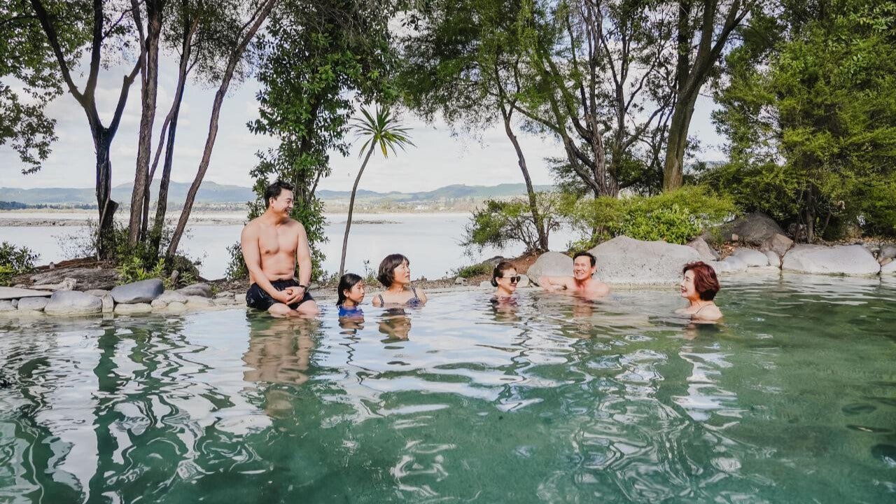 Group of friends enjoying the mineral hot pools at Polynesian Spa in Rotorua