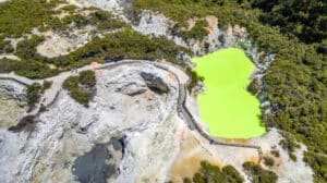 Aerial view of a bright green geothermal pond at Wai-O-Tapu in Rotorua