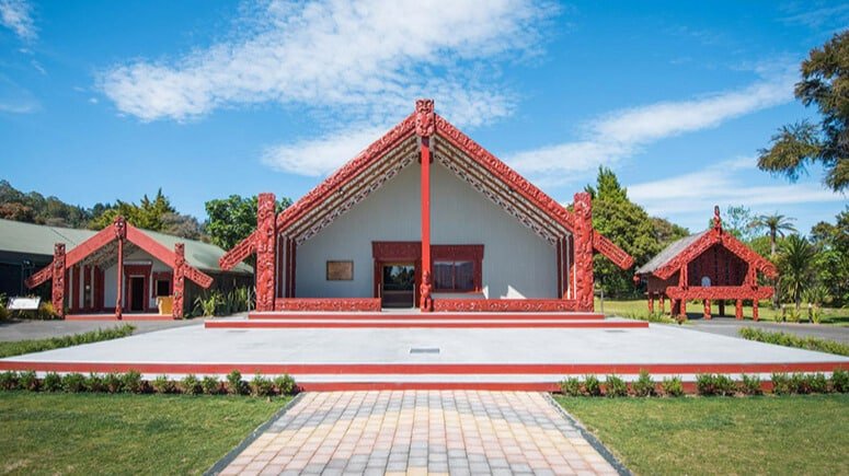 Traditional Māori marae with carved wooden details at Te Puia in Rotorua, New Zealand
