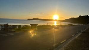 Sunset casting warm orange glow behind the edge of Waiheke Island