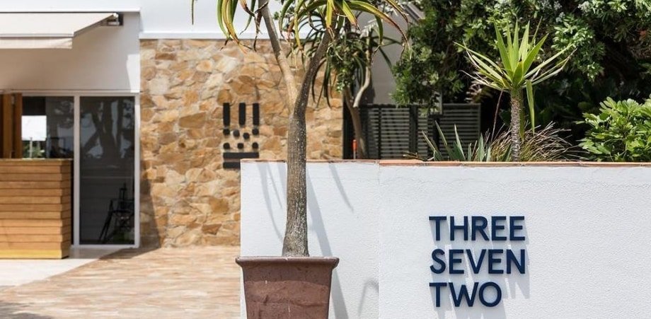 Outdoor dining at Three Seven Two restaurant on Waiheke Island, surrounded by greenery and coastal views