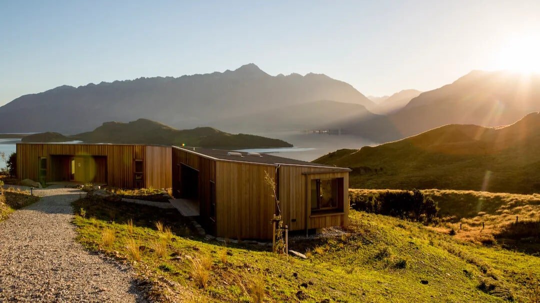 Modern architectural buildings seamlessly integrated into the natural landscape at Aroha Wellness Retreat.