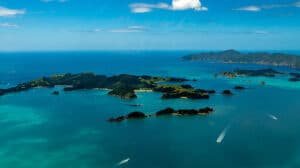Aerial view of the Bay of Islands with boats cruising through the sparkling blue waters.