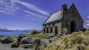 Iconic Church of the Good Shepherd on the shores of Lake Tekapo with mountain and lake views during a Christchurch to Queenstown small group tour
