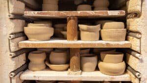 Full kiln filled with pottery pieces drying after class at Driving Creek pottery workshop.