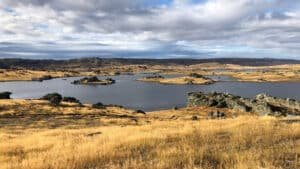 Taieri Gorge train passing near Poolburn with rugged rocky hills and scenic Otago landscapes