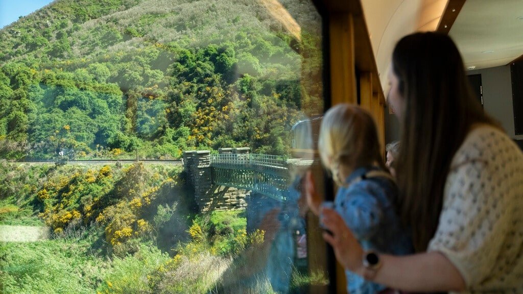 Taieri Gorge Railway train passing through dramatic landscapes, cliffs and rivers on a scenic journey