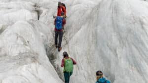 Group of hikers tramping across ice and snow on a helihike tour of Tasman Glacier from Queenstown