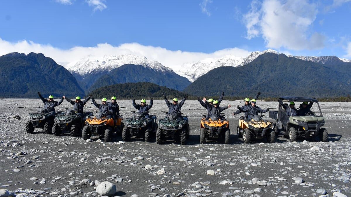 Small group of riders on quad bikes enjoying an off-road adventure tour in Franz Josef.