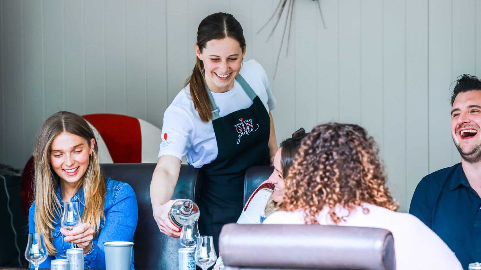 Pouring a glass of gin during a tasting session on the Queenstown Gin Tour.