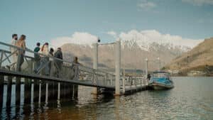 Guests boarding a boat cruise from a jetty on Lake Wakatipu in Queenstown.