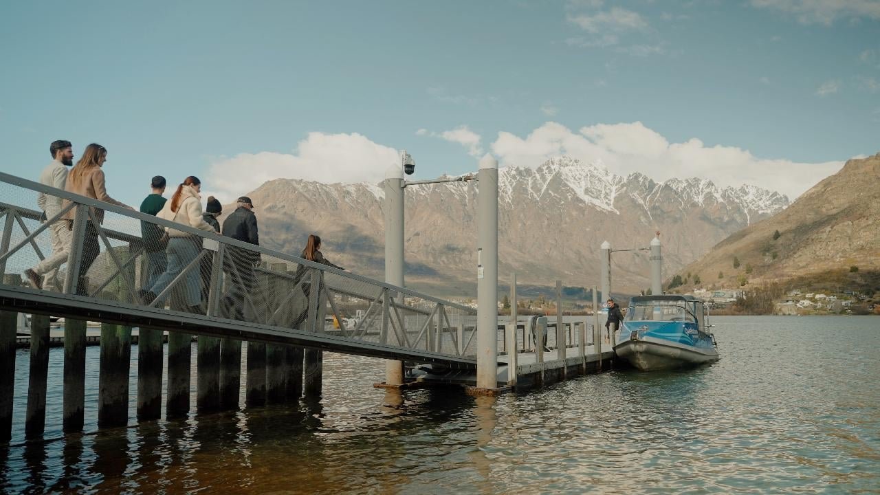 Guests boarding a boat cruise from a jetty on Lake Wakatipu in Queenstown.