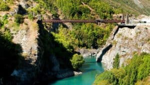 Historic bridge over a river set up for bungy jumping in Queenstown, New Zealand.