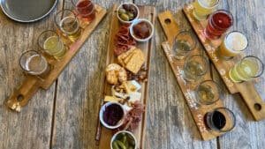 Tasting paddles of craft beer with gourmet platters on a Queenstown twilight wine and beer tour