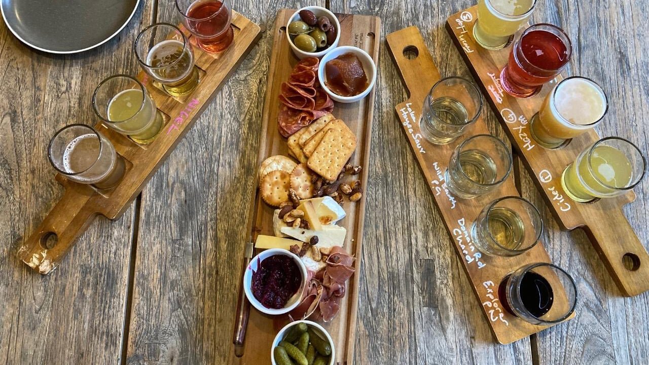 Tasting paddles of craft beer with gourmet platters on a Queenstown twilight wine and beer tour