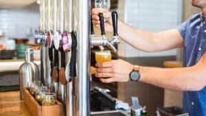 Bartender pouring a fresh craft beer on a Queenstown twilight wine and beer tasting tour