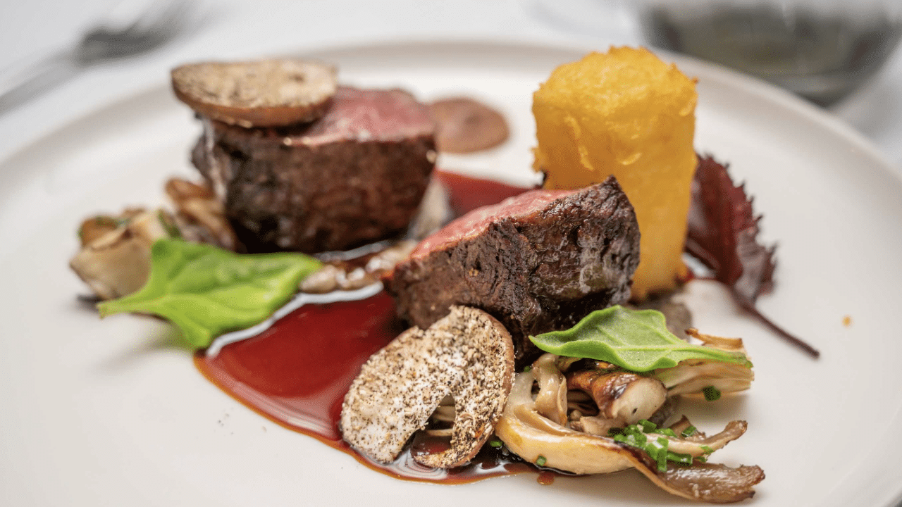 Plate of medium rare eye fillet steak served with fresh vegetables during Waiheke wine and dine tour