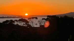 Vivid red and orange sunset sky over Waiheke Island vineyards