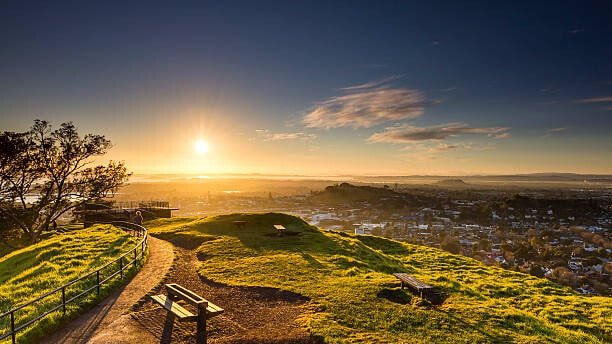 Sunset over Auckland city skyline as seen from Mt Eden on a small group tour