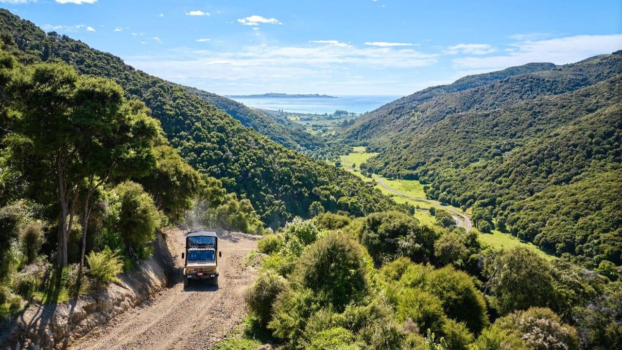 Unimog 4x4 driving up winding mountain trail to EcoZip Kaikōura zipline platform