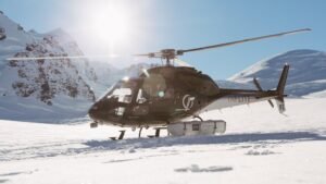 Helicopter landed on snowy mountain terrain during Mount Cook day tour from Christchurch via Tekapo