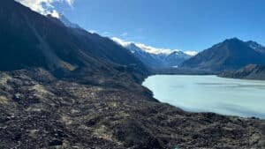 Rocky alpine landscape with Tasman Lake and surrounding snow-capped mountains on a Mount Cook tour from Queenstown