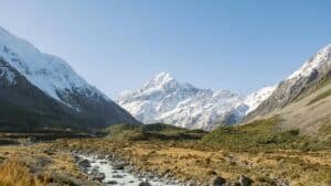 Snow-capped mountains towering over Hooker Valley in New Zealand’s Southern Alps