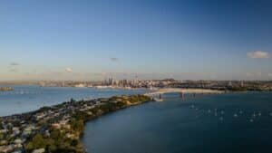 View of Auckland City skyline and Sky Tower seen from the North Shore side of the Harbour Bridge