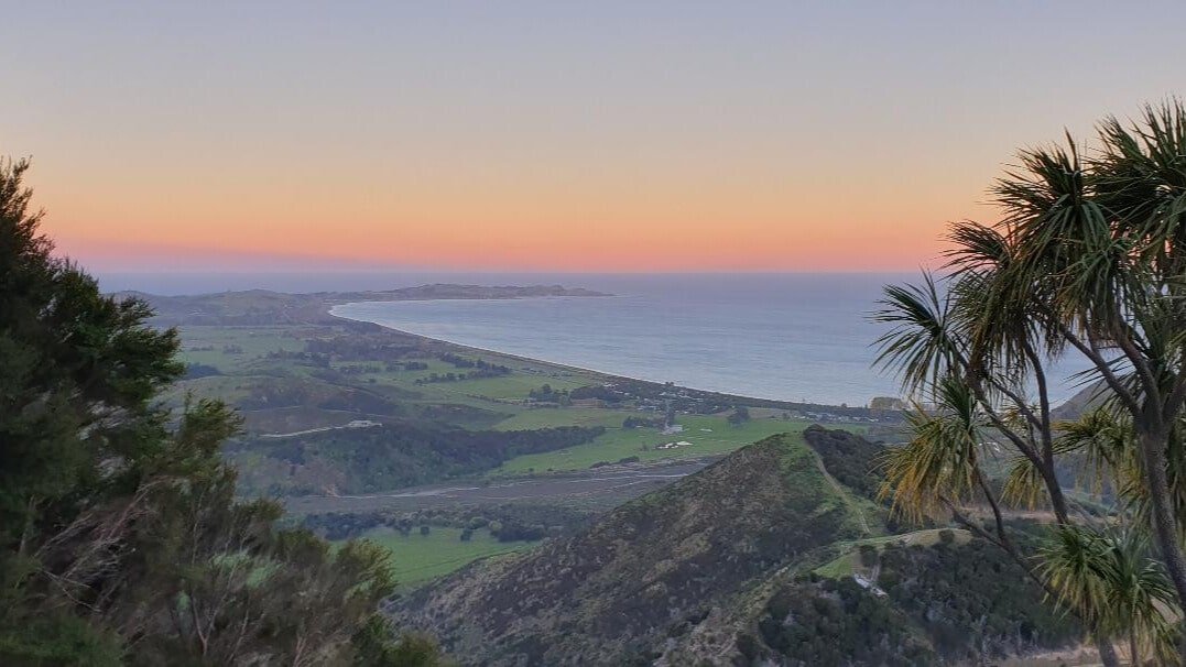 Golden sunset over mountain ranges from Kaikōura zipline platform