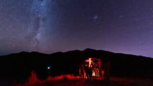 Red safety lights under a clear, star-filled night sky perfect for stargazing in Kaikōura