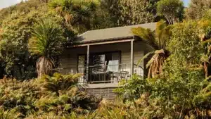 Villa with balcony overlooking native forest at Maruia River Retreat accommodation