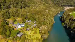 Aerial shot showing Maruia River Retreat buildings beside river and native bush