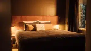 Cozy bedroom with a neatly made bed at Maruia River Retreat accommodation
