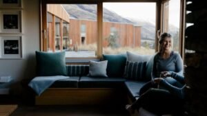 Guests in focused conversation and learning in a cosy, beautifully designed nook at Aro Hā Wellness Retreat