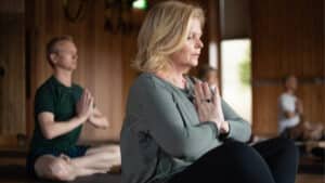 Guests sitting in group meditation at Aro Hā Wellness Retreat in a light-filled studio